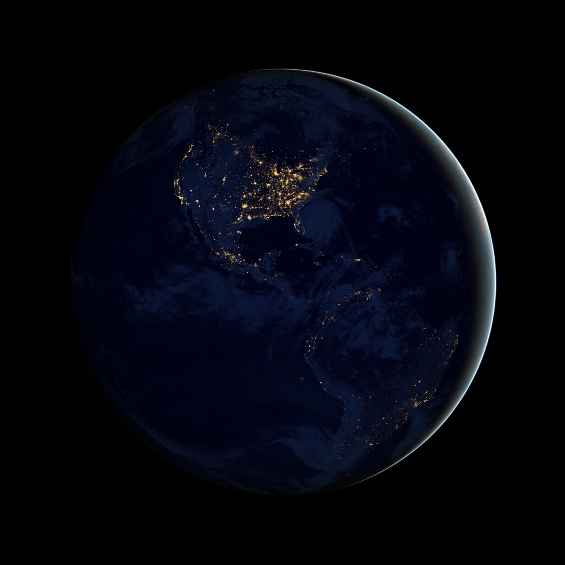 The Americas at night appear as concentrations of light joined across a dark continent.