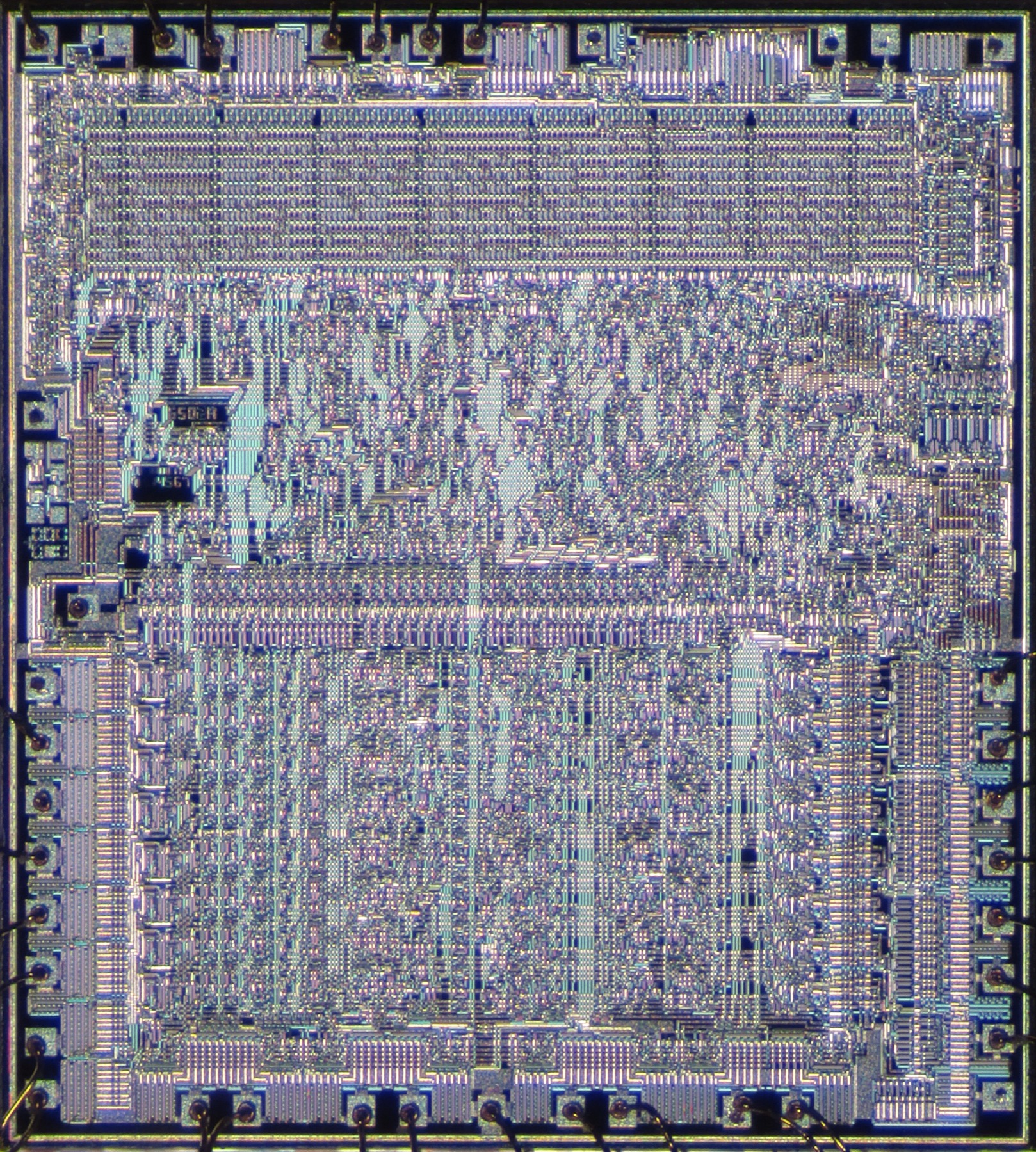 A microphotograph of a MOS 6502 processor shows blocks of circuitry connected by dense traces.